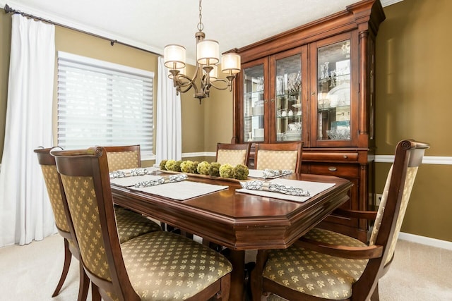 dining space with light carpet, a notable chandelier, and baseboards