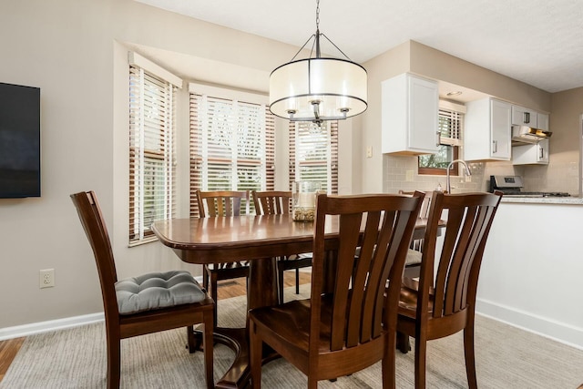 dining area with baseboards and an inviting chandelier