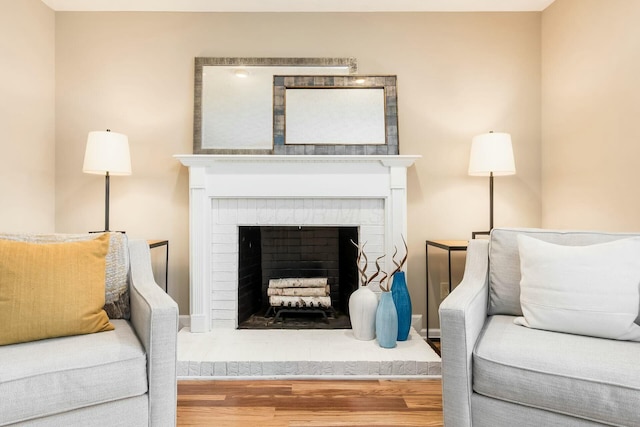 living room featuring wood finished floors and a fireplace