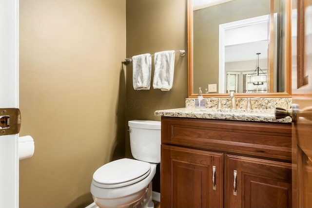 bathroom with toilet and vanity