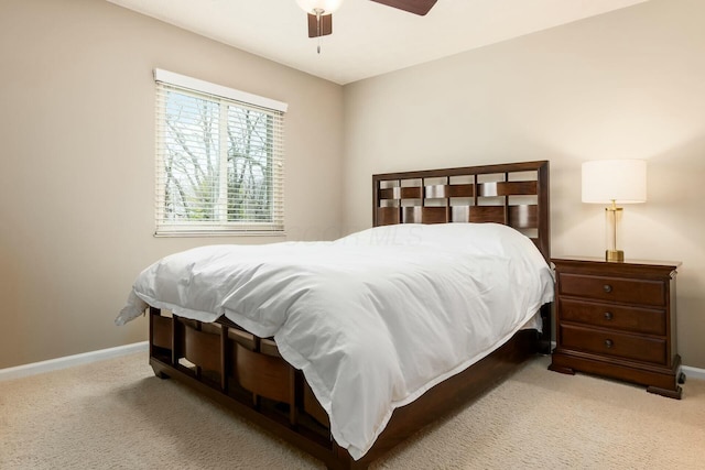 bedroom with ceiling fan, carpet floors, and baseboards