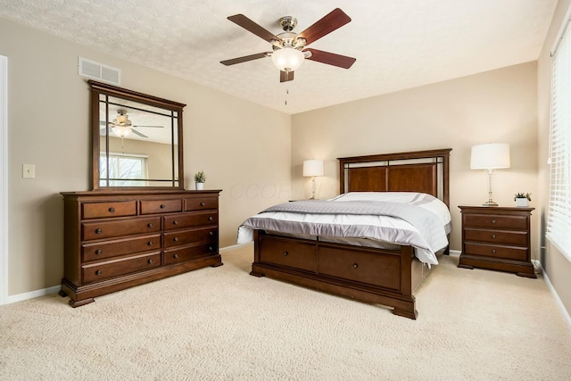 bedroom with baseboards, a ceiling fan, visible vents, and carpet