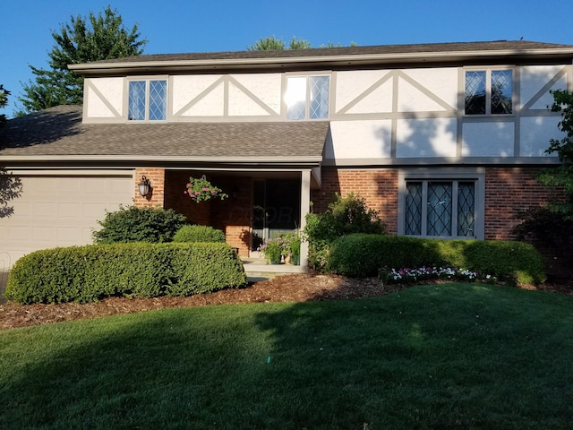 7918 Sethwick Rd, Dublin, OH 43016 - tudor home featuring brick siding, a front yard, and an attached garage