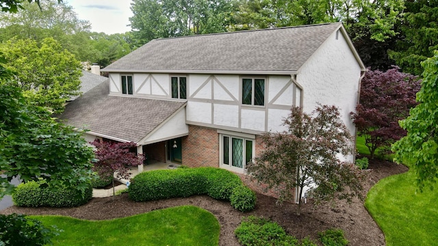 7918 Sethwick Rd, Dublin, OH 43016 - view of front facade featuring stucco siding, a shingled roof, and brick siding