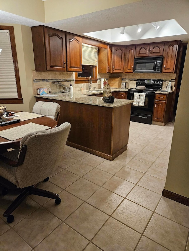 7918 Sethwick Rd, Dublin, OH 43016 - kitchen with black appliances, a sink, decorative backsplash, and a peninsula