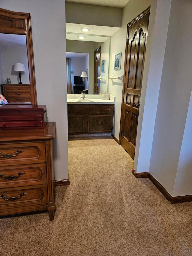 7918 Sethwick Rd, Dublin, OH 43016 - hallway with light carpet, a sink, and baseboards