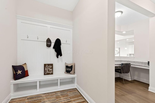 2418 Home Rd, Powell, OH 43065 - mudroom featuring baseboards, wood finished floors, and built in desk