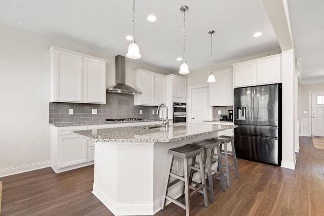 2418 Home Rd, Powell, OH 43065 - kitchen with dark wood-style flooring, wall chimney range hood, stainless steel appliances, and a sink