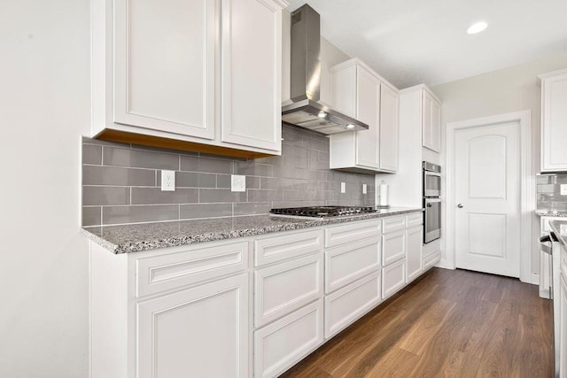 2418 Home Rd, Powell, OH 43065 - kitchen featuring dark wood finished floors, wall chimney exhaust hood, stainless steel gas cooktop, tasteful backsplash, and white cabinetry