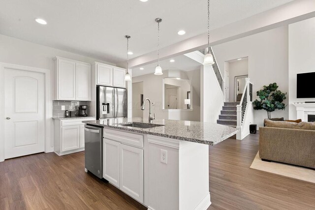 2418 Home Rd, Powell, OH 43065 - kitchen with open floor plan, appliances with stainless steel finishes, a sink, and dark wood-type flooring