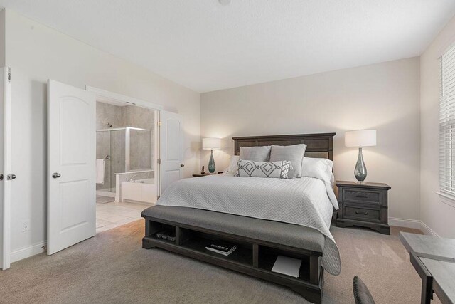 2418 Home Rd, Powell, OH 43065 - bedroom featuring light carpet, ensuite bathroom, and baseboards