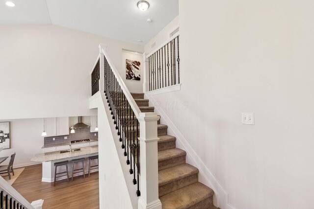 2418 Home Rd, Powell, OH 43065 - stairway featuring wood finished floors
