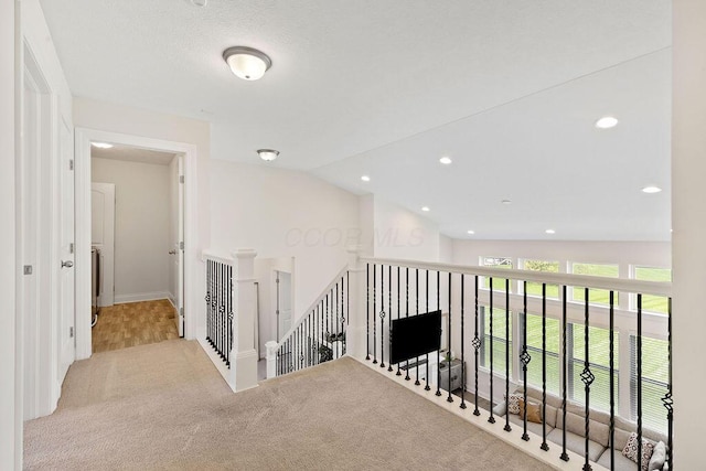 2418 Home Rd, Powell, OH 43065 - hallway featuring lofted ceiling, carpet flooring, recessed lighting, and an upstairs landing
