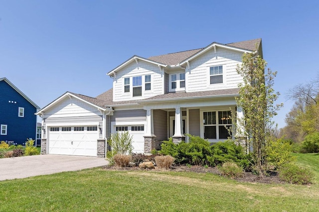 2418 Home Rd, Powell, OH 43065 - craftsman inspired home featuring stone siding, a porch, concrete driveway, a garage, and a front yard