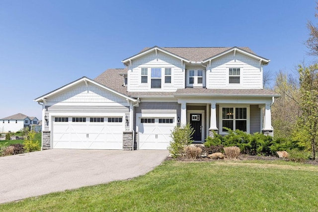 2418 Home Rd, Powell, OH 43065 - craftsman-style home with a porch, stone siding, a shingled roof, a front yard, and aphalt driveway