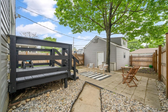 876 Palmer Rd, Columbus, OH 43212 - view of patio with a fenced backyard, a wooden deck, and an outbuilding