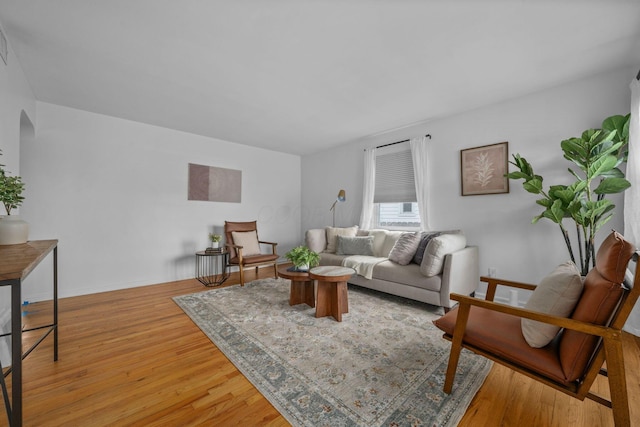 876 Palmer Rd, Columbus, OH 43212 - living area featuring light wood-style floors, arched walkways, and baseboards