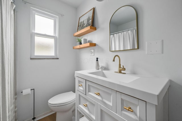 876 Palmer Rd, Columbus, OH 43212 - bathroom featuring toilet, baseboards, wood finished floors, and vanity