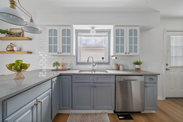 876 Palmer Rd, Columbus, OH 43212 - kitchen featuring open shelves, a sink, light wood-type flooring, stainless steel dishwasher, and gray cabinetry