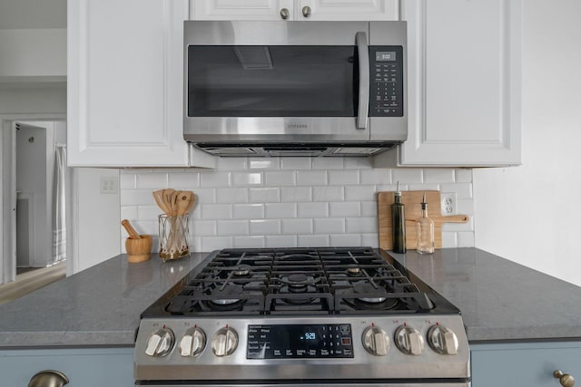876 Palmer Rd, Columbus, OH 43212 - kitchen featuring white cabinets, appliances with stainless steel finishes, and tasteful backsplash