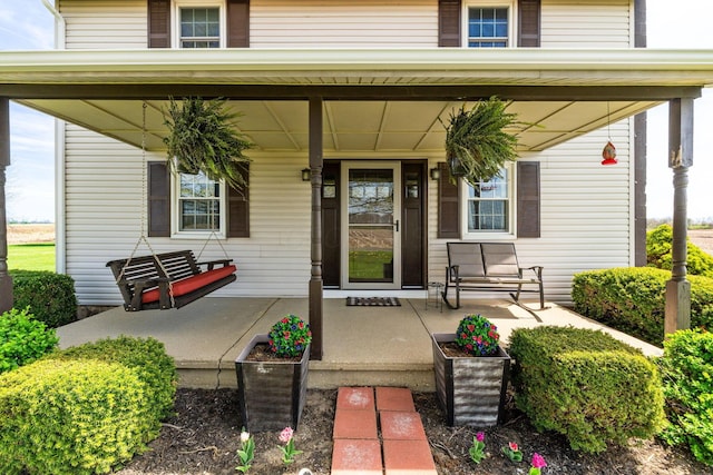 entrance to property featuring a porch