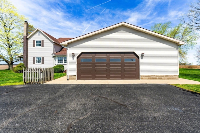 view of front of property featuring fence and driveway