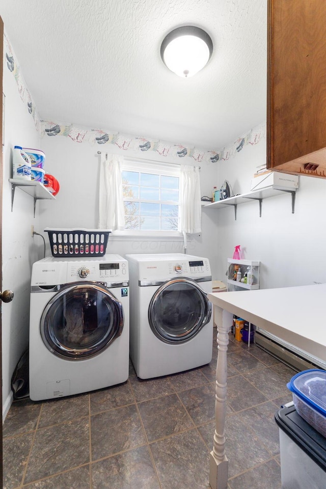 laundry room featuring stone finish flooring, washer and dryer, a textured ceiling, and laundry area