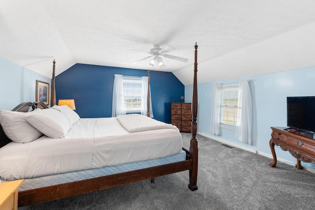 bedroom featuring lofted ceiling, visible vents, carpet floors, and multiple windows