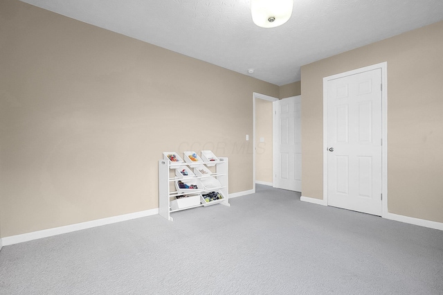 unfurnished bedroom with baseboards and carpet