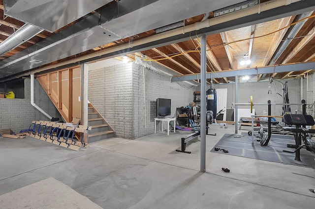 workout area featuring brick wall