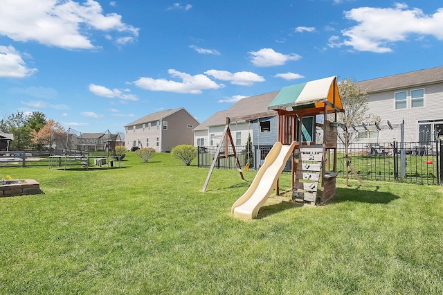 view of play area featuring a fire pit, a residential view, a trampoline, and fence