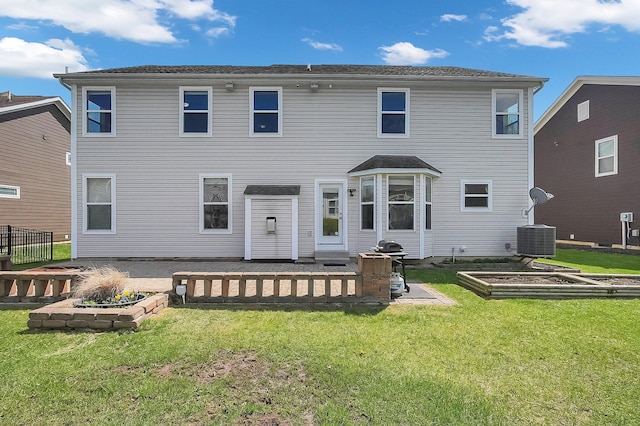 back of property with a yard, a vegetable garden, and central AC unit