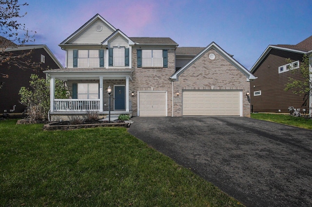 view of front of house featuring driveway, an attached garage, a porch, a yard, and brick siding