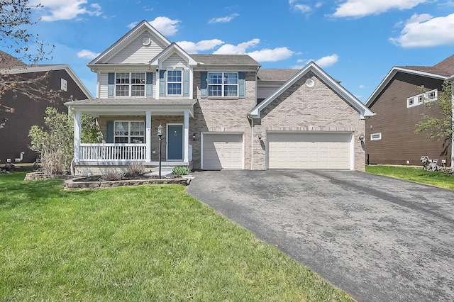 view of front facade featuring brick siding, aphalt driveway, a porch, and a front yard