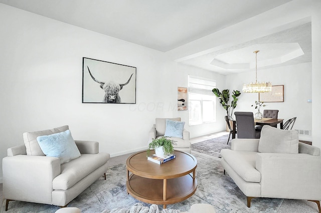 living room with baseboards, a chandelier, and visible vents