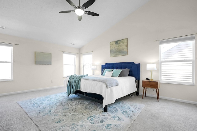 carpeted bedroom featuring high vaulted ceiling, ceiling fan, baseboards, and visible vents