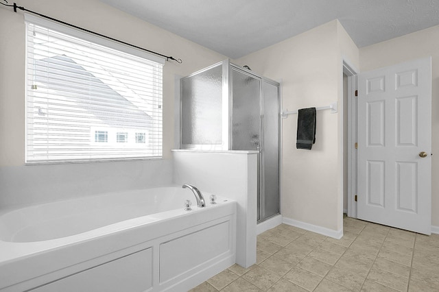 bathroom featuring a bath, tile patterned floors, baseboards, and a shower stall