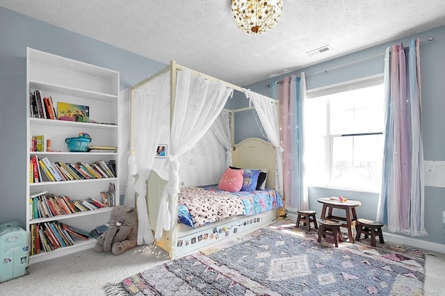 carpeted bedroom with visible vents and a textured ceiling