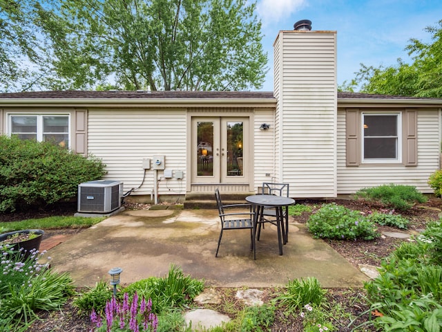 3794 Bridle Ct, Columbus, OH 43221 - back of house with central AC unit, french doors, a patio, and a chimney