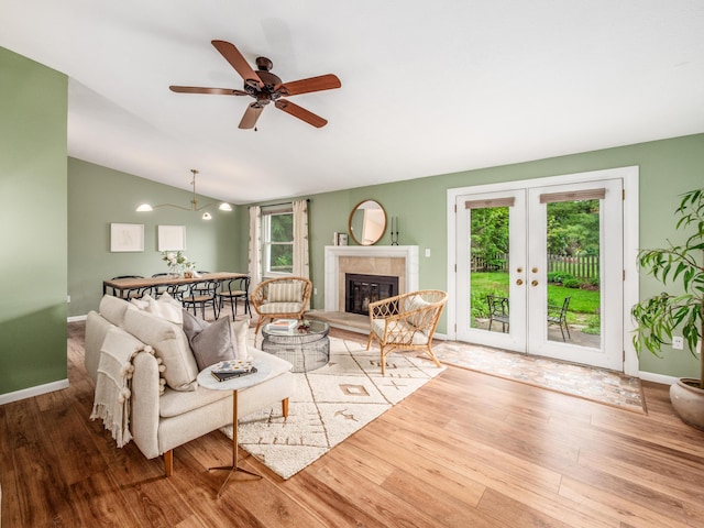 3794 Bridle Ct, Columbus, OH 43221 - living area with wood finished floors, french doors, lofted ceiling, ceiling fan, and a tile fireplace