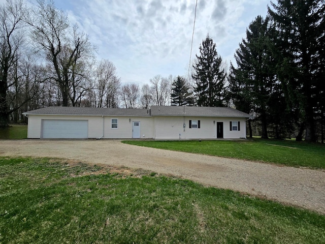 ranch-style home featuring a front lawn, driveway, and a garage