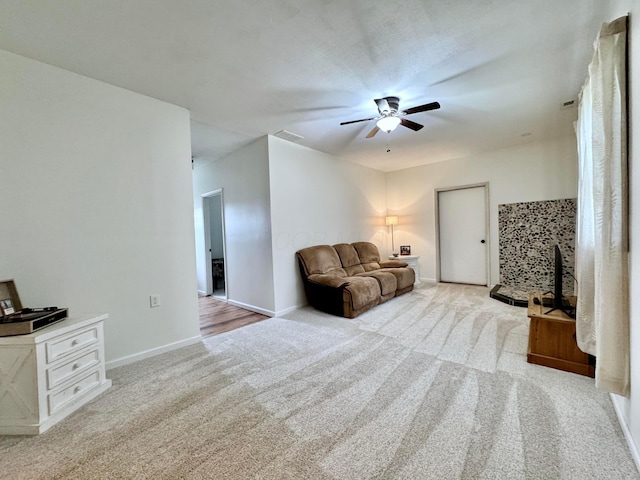 living room featuring baseboards, a ceiling fan, carpet flooring, and visible vents