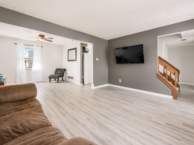 5407 Davidson Rd, Hilliard, OH 43026 - living room with visible vents, a textured ceiling, light wood finished floors, and baseboards