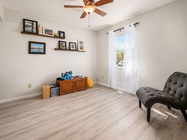 5407 Davidson Rd, Hilliard, OH 43026 - living area with a textured ceiling, baseboards, ceiling fan, and light wood-style floors