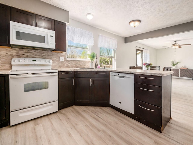 5407 Davidson Rd, Hilliard, OH 43026 - kitchen featuring white appliances, light countertops, light wood finished floors, and tasteful backsplash