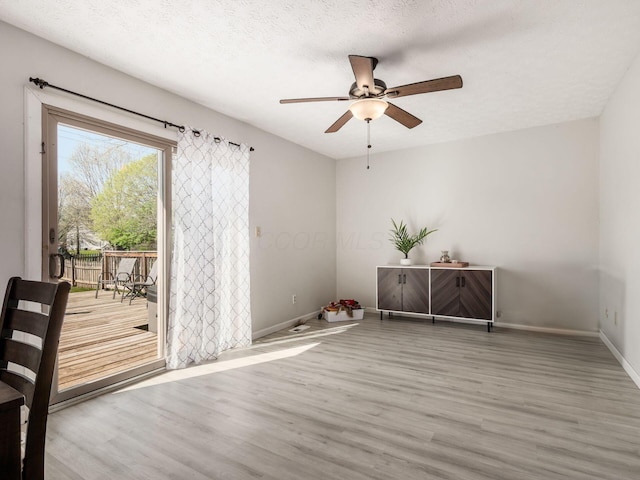 5407 Davidson Rd, Hilliard, OH 43026 - empty room with a ceiling fan, baseboards, wood finished floors, and a textured ceiling