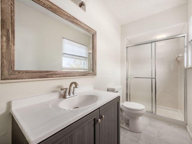 5407 Davidson Rd, Hilliard, OH 43026 - bathroom featuring vanity, marble finish floor, toilet, and a shower stall