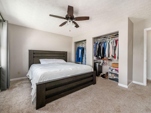 5407 Davidson Rd, Hilliard, OH 43026 - carpeted bedroom featuring multiple closets, baseboards, a ceiling fan, and a textured ceiling