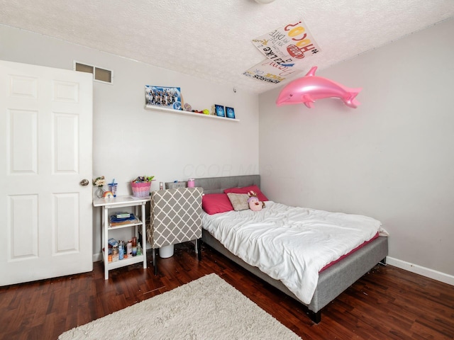 5407 Davidson Rd, Hilliard, OH 43026 - bedroom with baseboards, a textured ceiling, visible vents, and wood finished floors
