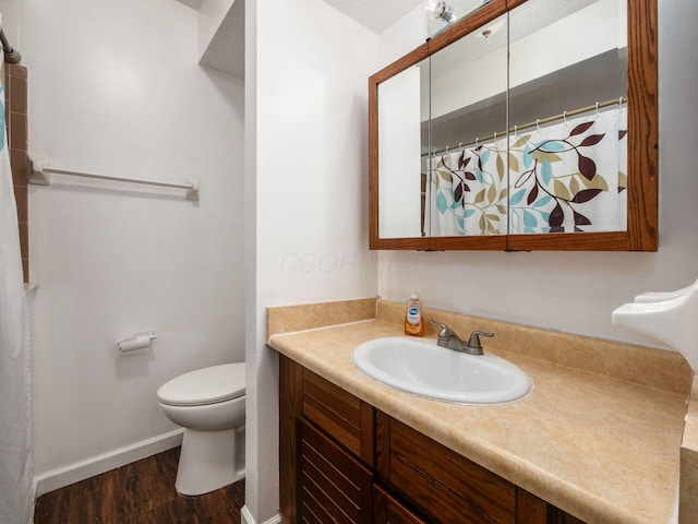 5407 Davidson Rd, Hilliard, OH 43026 - full bathroom with vanity, wood finished floors, toilet, baseboards, and a shower with curtain